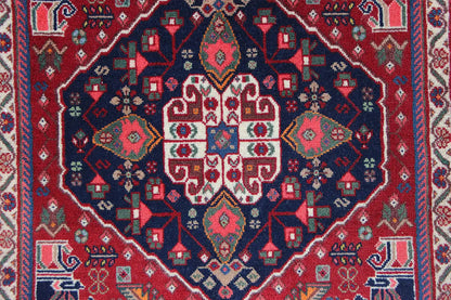 Qashqai rug by Poschti: Detail of the geometric pattern with a red and dark blue color palette.