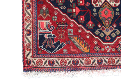 Qashqai rug by Poschti: close-up of the border, red patterned band with fringes.