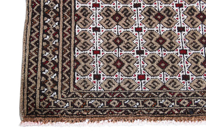 Close-up of a Turkmen carpet: border with decorative stripes, with fringe along the edge below
