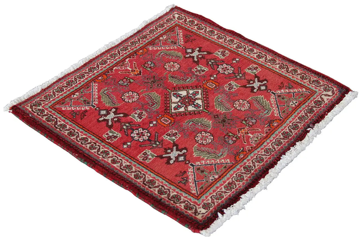 Red carpet with a detailed central motif, border, and white fringe