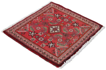 Red carpet with a detailed central motif, border, and white fringe