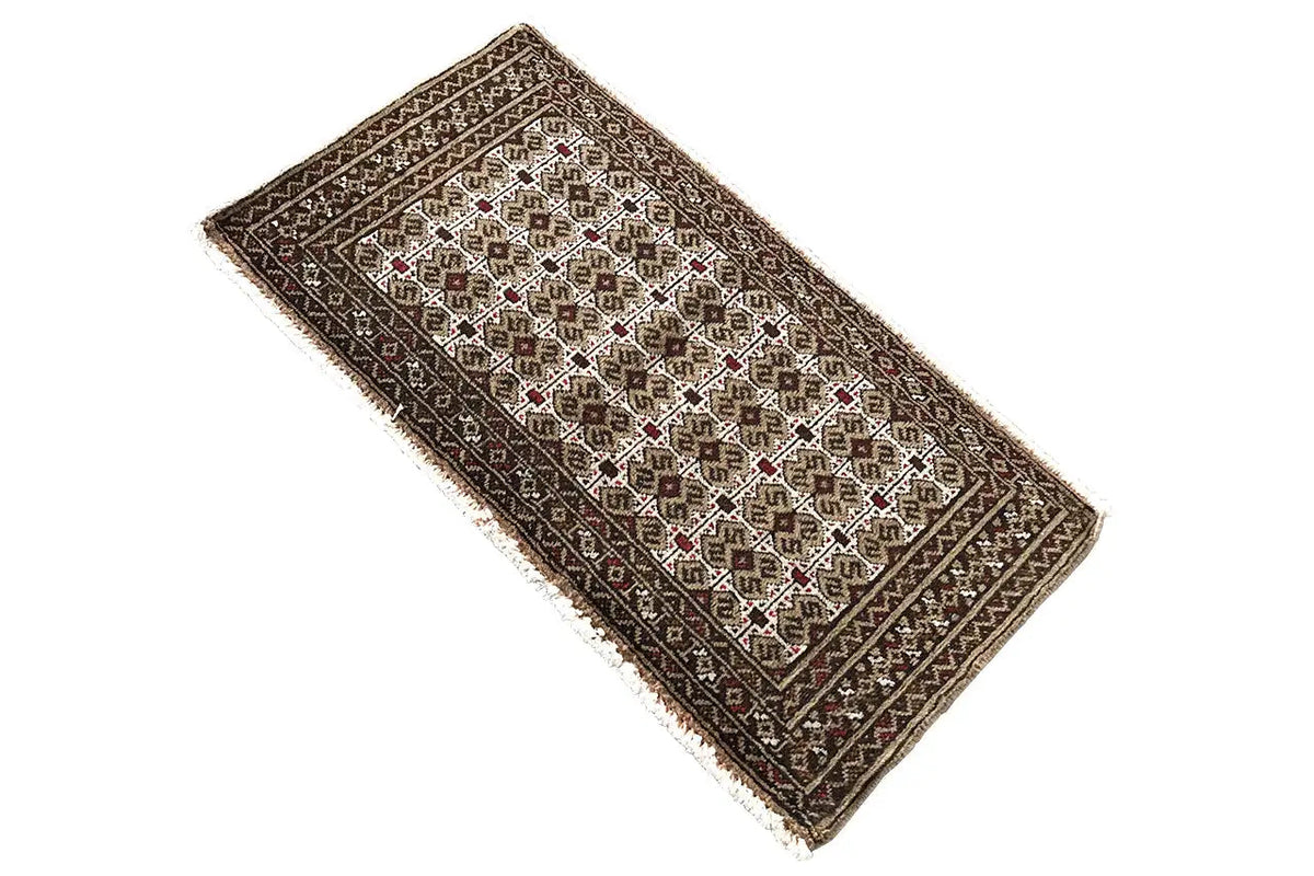 Turkmen carpet 100x52 cm, angled view, dark base design with white ornamental insert