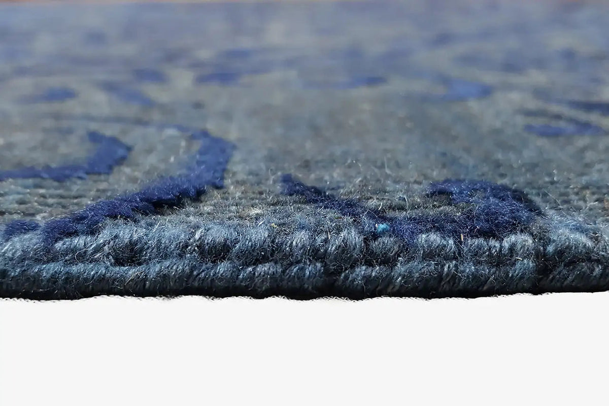 Close-up of carpet pile: short, dense fibers in blue-gray