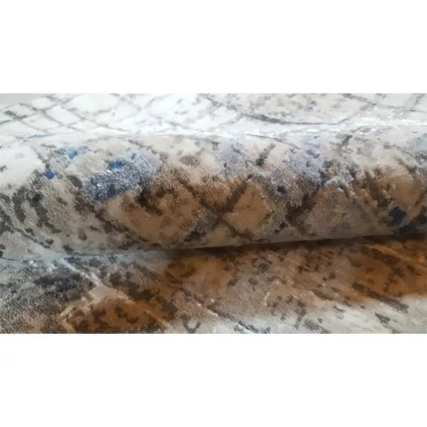 Rug with an abstract vintage pattern, beige-gray background and blue accents, close-up