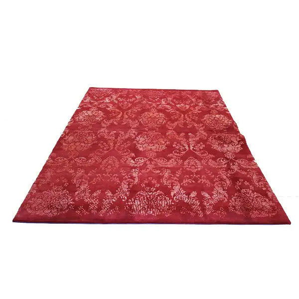 Red rectangular rug with an ornate damask pattern, top view