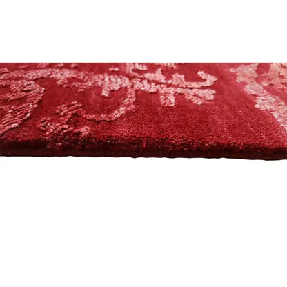 Close-up: red carpet with a relief-like ornamental design and pile