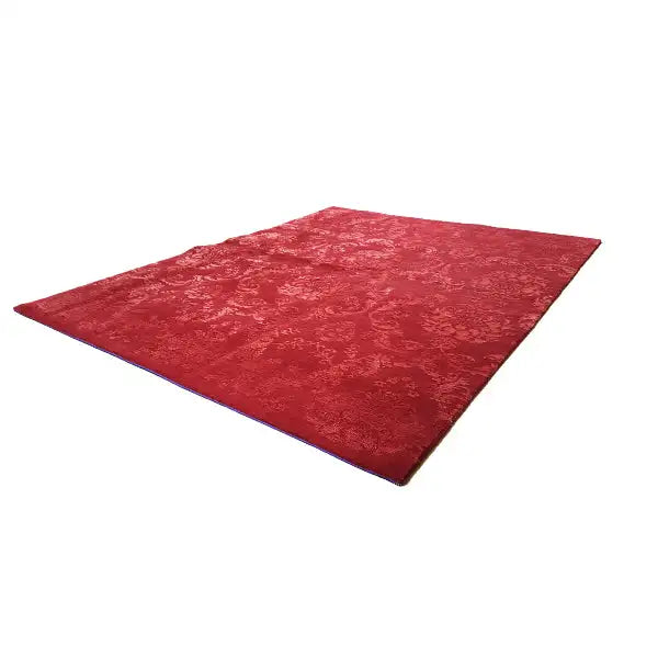 Red carpet with ornamental embossing, diagonal top view
