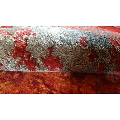 Carpet detail with deep pile, abstract patches of red and gray