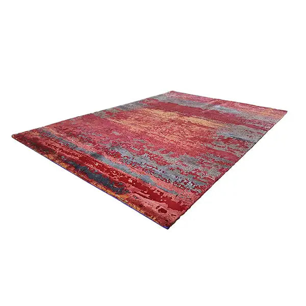 Rectangular rug with abstract brush textures in red, gray, and gold tones