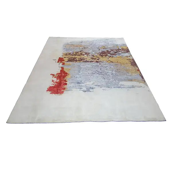Designer rug from above, light gray with red and yellow-brown accents