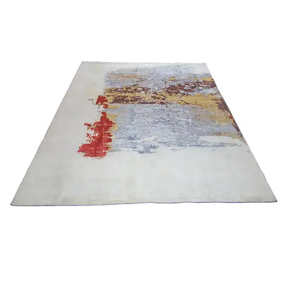 Designer rug from above, light gray with red and yellow-brown accents