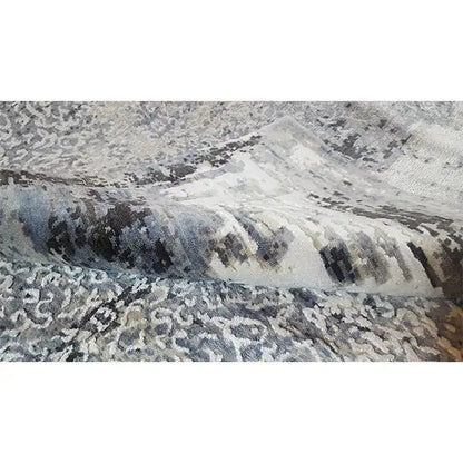 Carpet detail with blue-gray and beige patches of color, abstractly textured