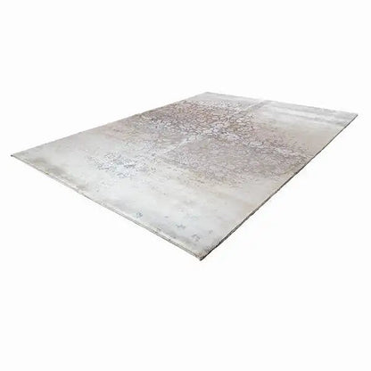 Rectangular rug with a light beige base and gray ornamental and textured pattern
