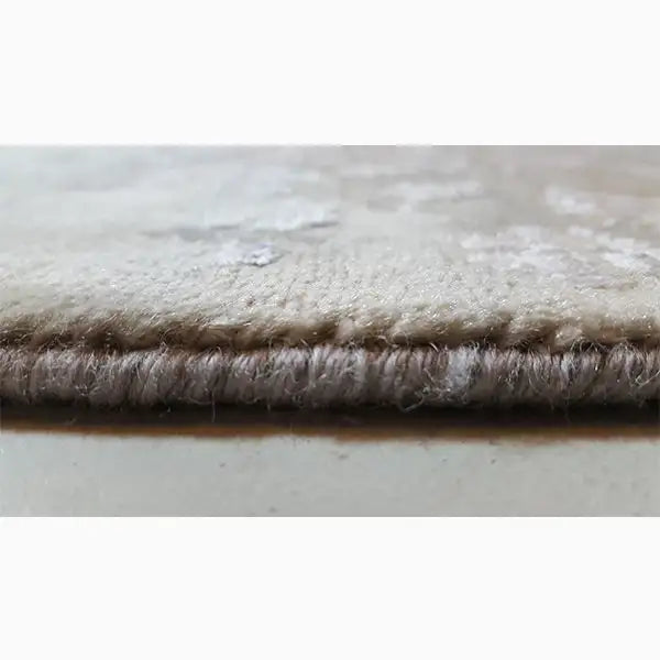 Rug edge with dense, short pile and gray-beige fabric