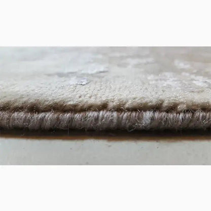 Rug edge with dense, short pile and gray-beige fabric