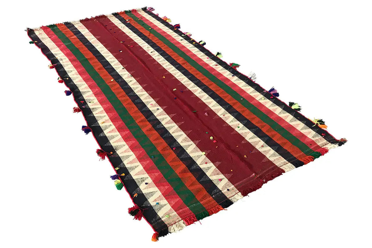 Jajim rug with diagonal stripes in shades of red, green, and blue, tassels along the edge