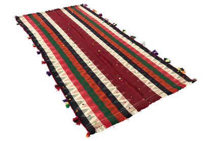 Jajim rug with diagonal stripes in shades of red, green, and blue, tassels along the edge