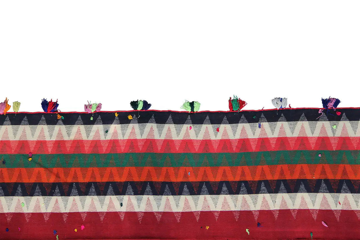 Jajim rug front edge: zigzag and triangular design, fringe with colorful tassels