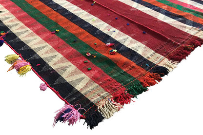 Jajim rug corner with fringes and tassels, striped color gradient in red, green, blue
