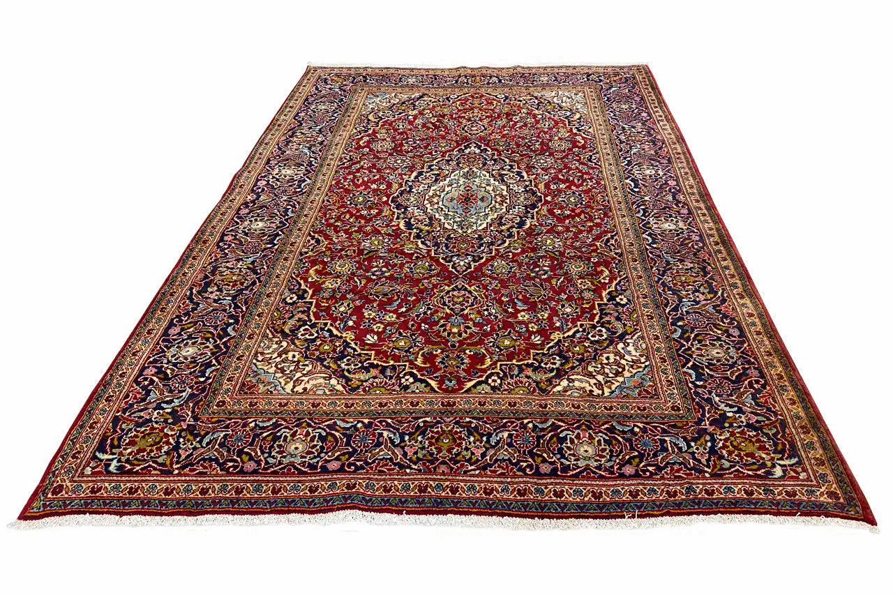 Red and multicolored oriental rug with a central medallion, surrounding border, and ornaments