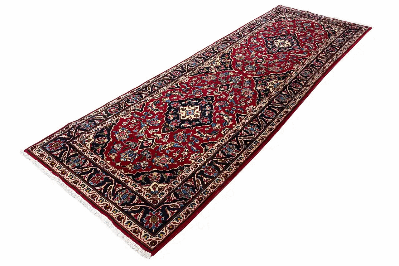Red oriental rug with medallion pattern and blue border frame