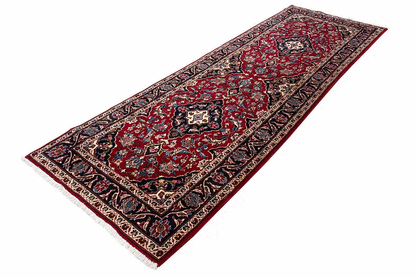 Red oriental rug with medallion pattern and blue border frame