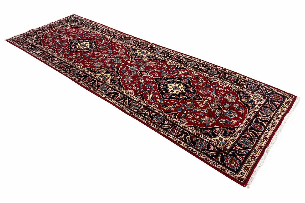 Red oriental rug with a delicate border design and a large medallion