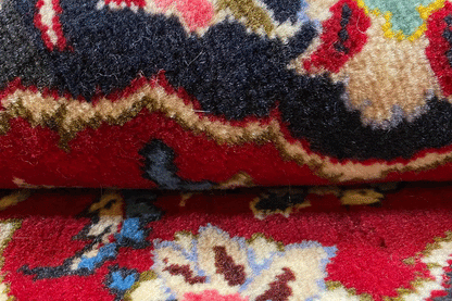 Carpet detail: red pile with a multicolored ornamental pattern