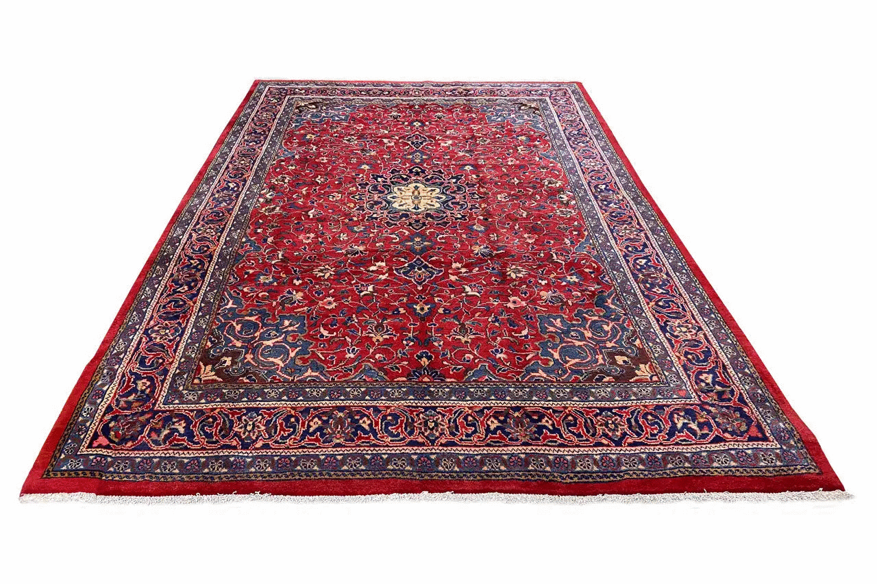 Rectangular red rug with a blue border and delicate ornaments