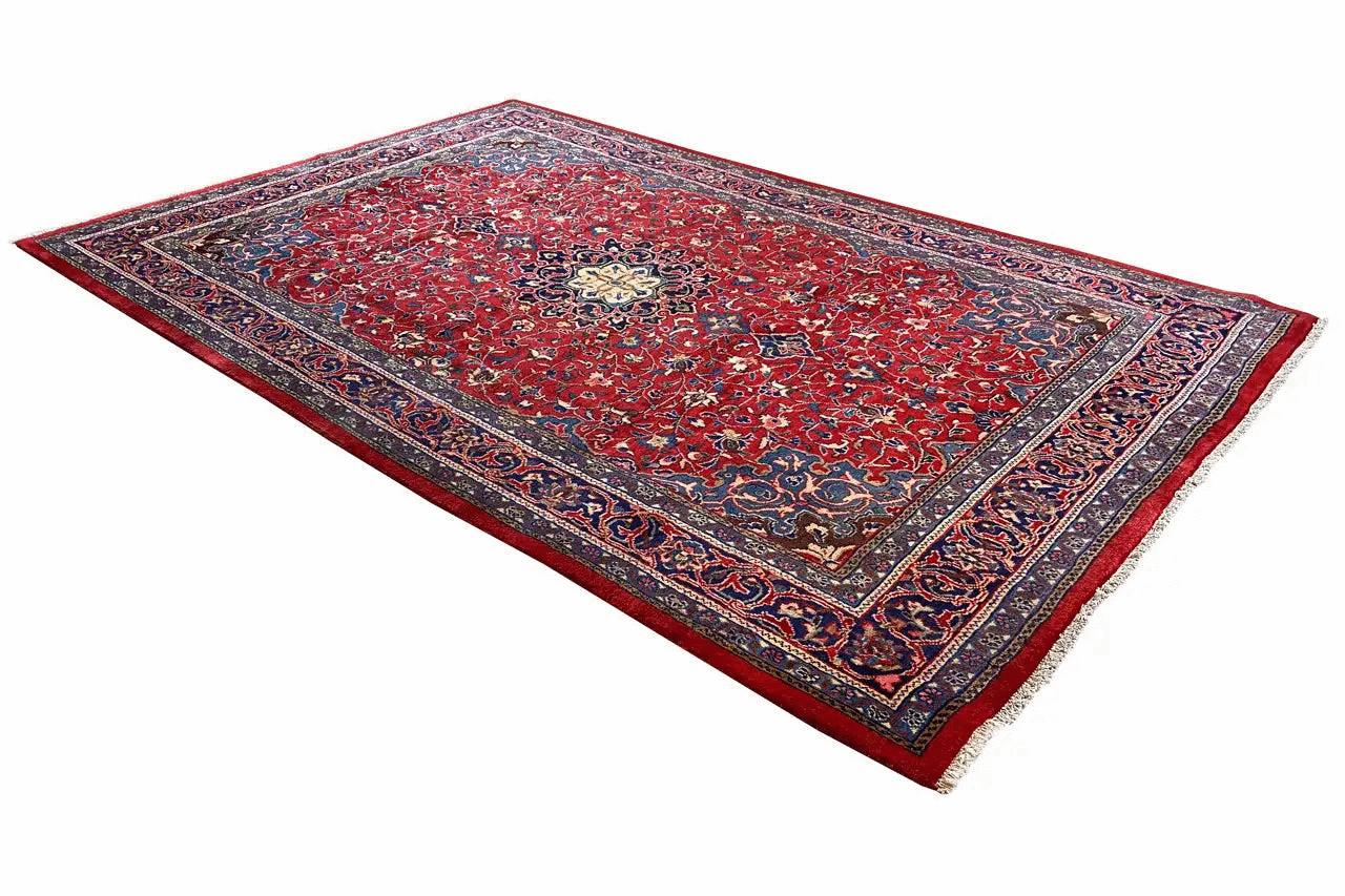 Red carpet with a blue border, central medallion, and delicate pattern