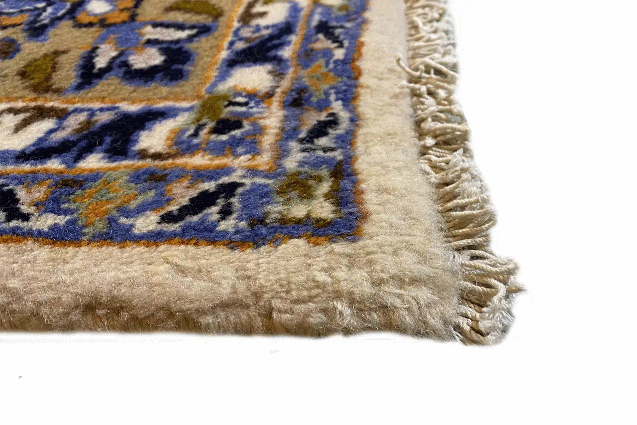 Keshan rug border with fringe and a blue-and-white pattern