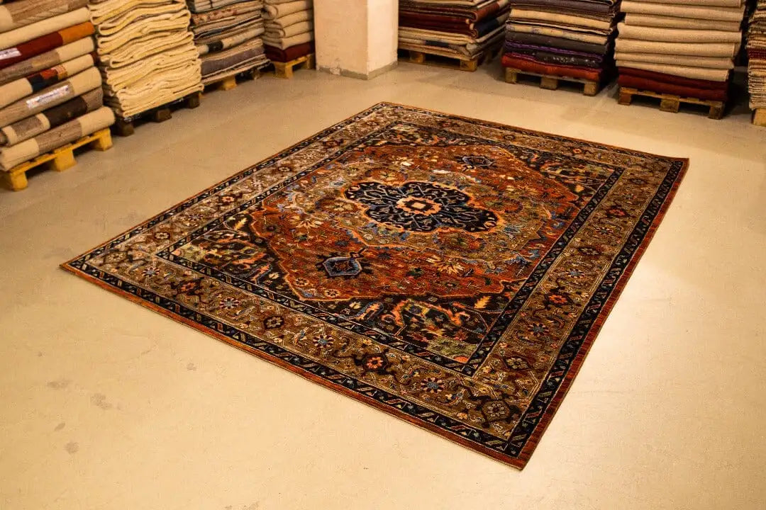 Ornamental rug in copper, blue, and beige with a dark border