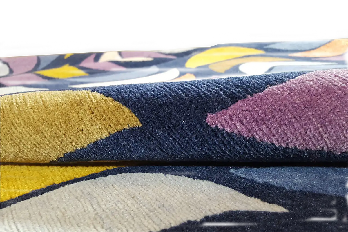 Rug with a wave pattern in blue, yellow, violet, and cream, laid flat