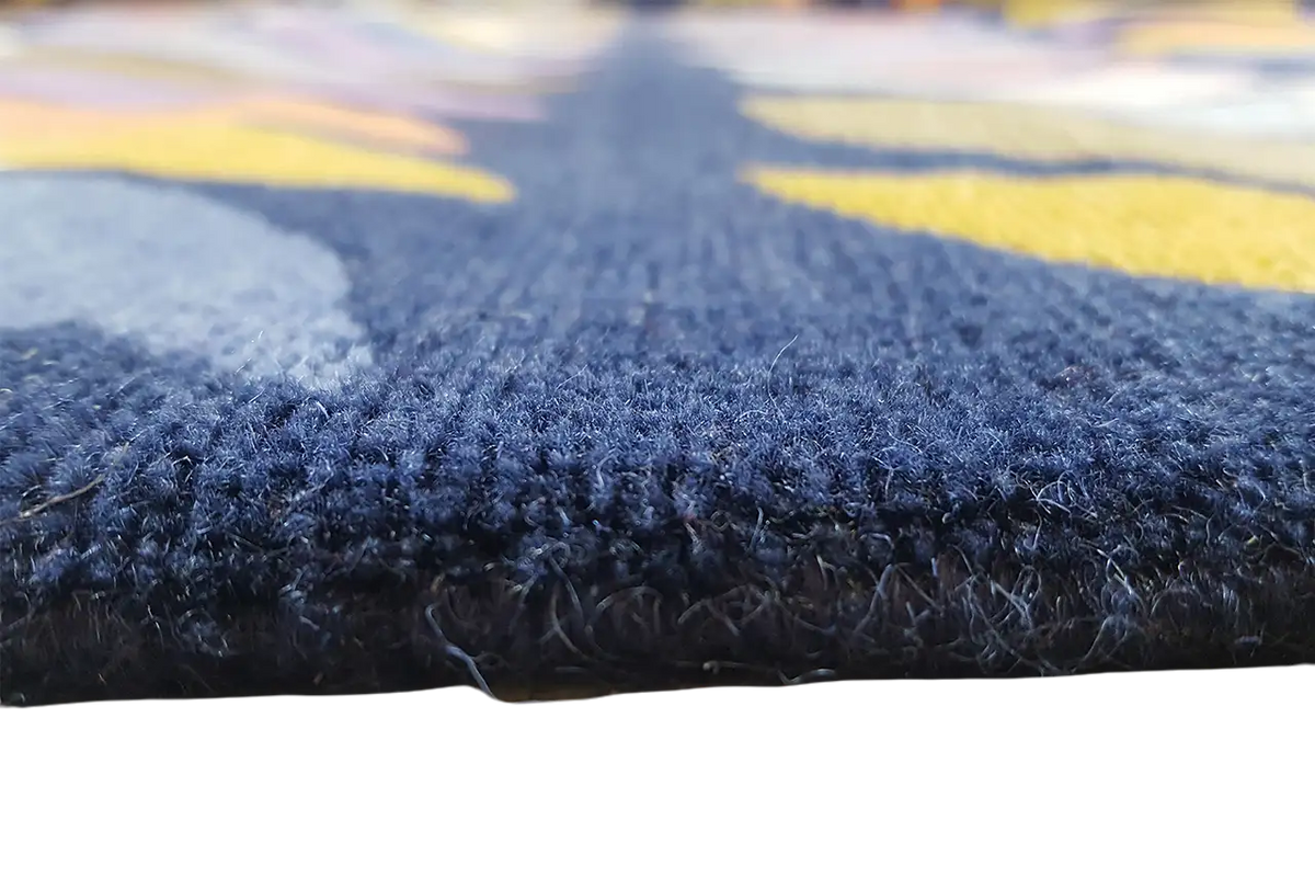 Blue carpet with a dense, short pile and colorful wave patterns in the background