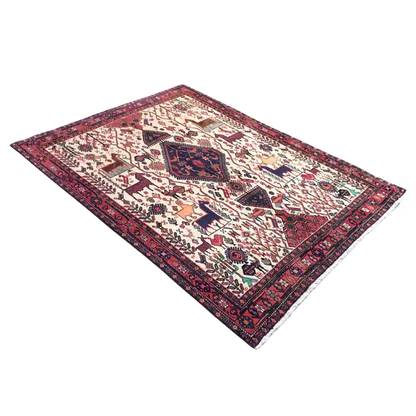 Rectangular rug with a white background, red border, and ornamental central motif