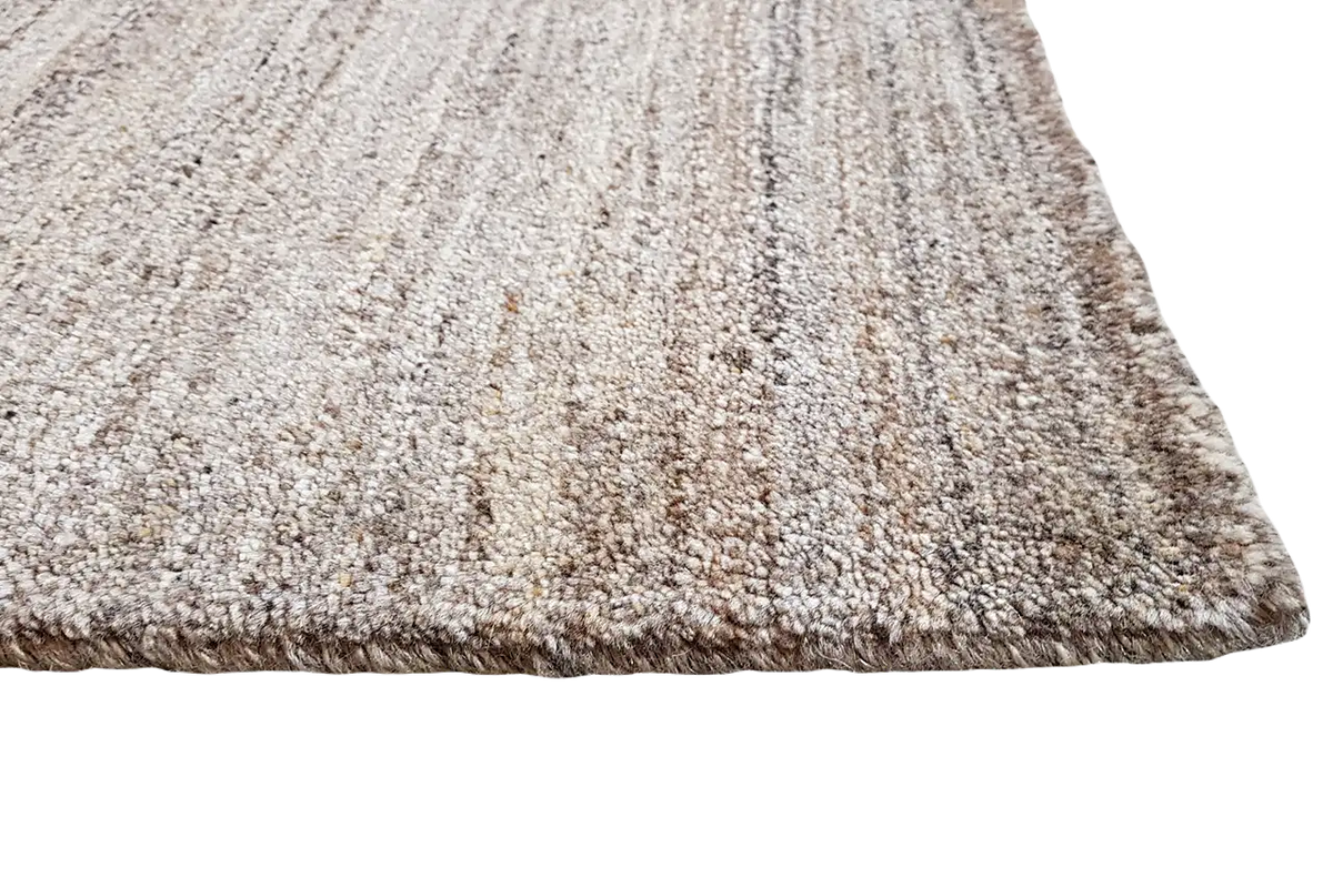 Gabbeh natural rug, light beige-brown texture with a mottled grain, edges visible