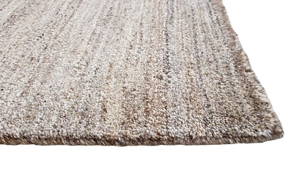 Gabbeh natural rug, light beige-brown texture with a mottled grain, edges visible