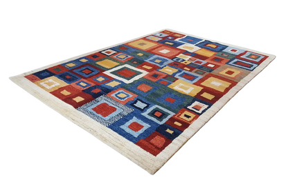 Rectangular rug with a square color pattern in blue, red, orange, and beige