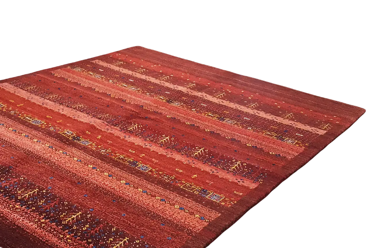 Gabbeh rug: wide reddish-brown stripes with fine dots and multicolored accents.