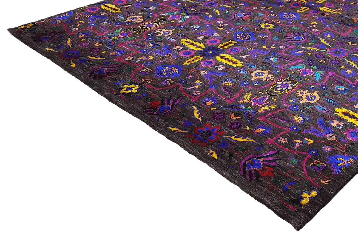 Silk sari spread diagonally, colorful ornamental pattern on a dark background