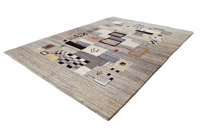 Rectangular Gabbeh rug with geometric patterns in black, red, and blue on a light background