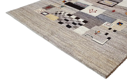 Gabbeh rug with striped and tile-like patterns in multiple colors on a beige background